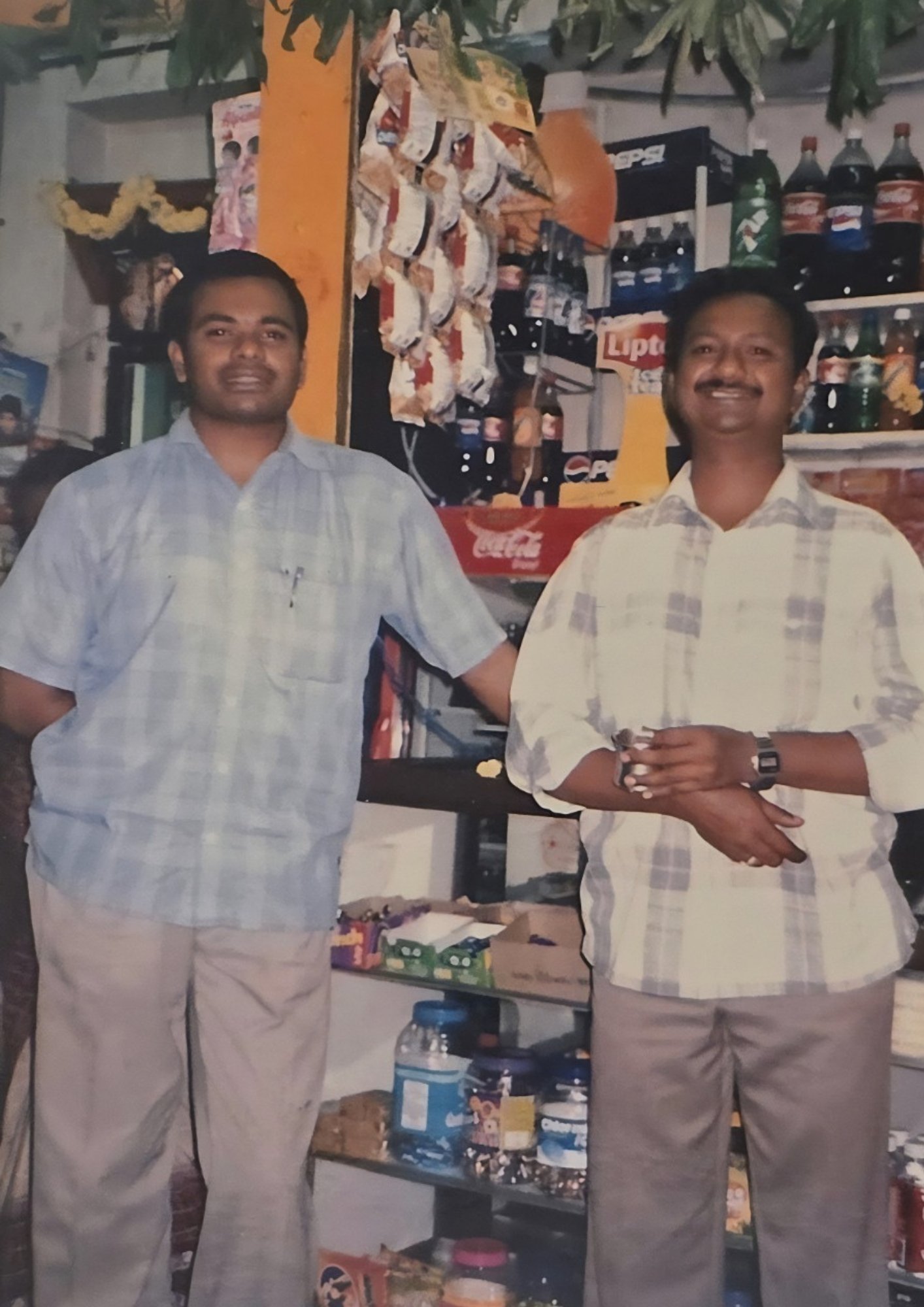Anil Chetty and Vinod Kumar standing inside the original Chetty's Corner shop in Bangalore, established in 1997
